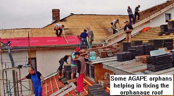 Some AGAPE orphans helping in fixing the orphanage roof